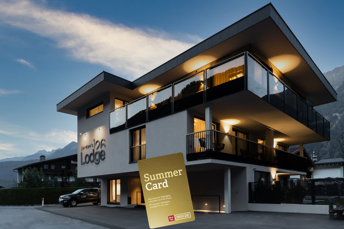 A modern building with balconies and a clear evening sky. In the foreground, a Summer Card is visible, representing summer offers.