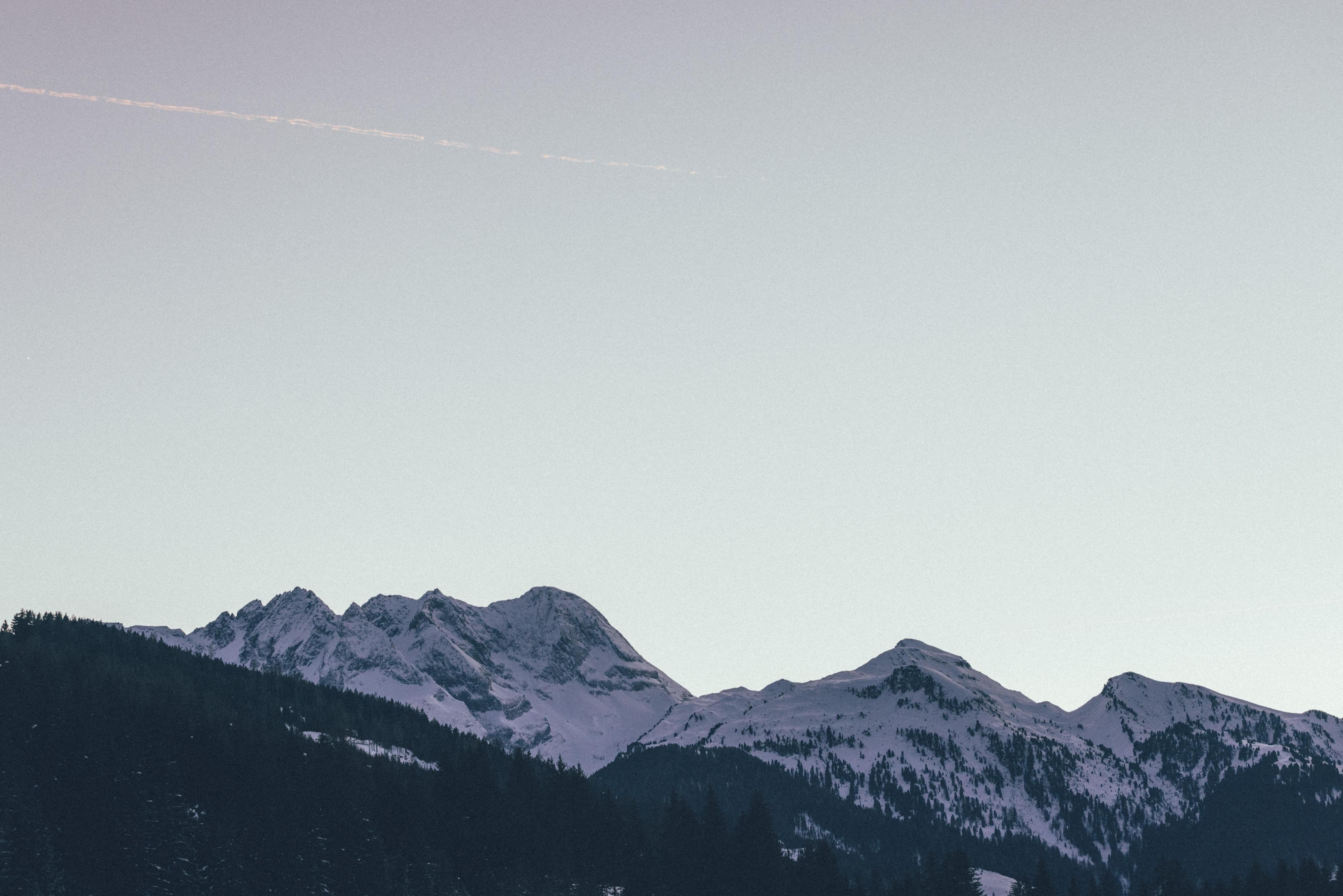 Snow-covered mountains under a clear sky. The landscape is calm and breathtaking.
